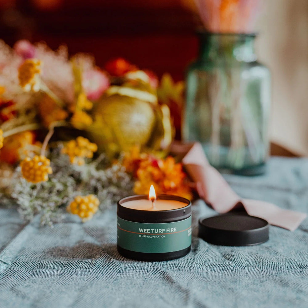 Illuminated candle on a table.