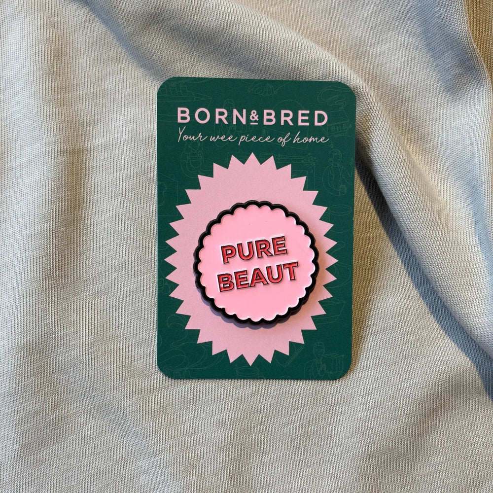 Pure Beaut pin on cardboard backing.